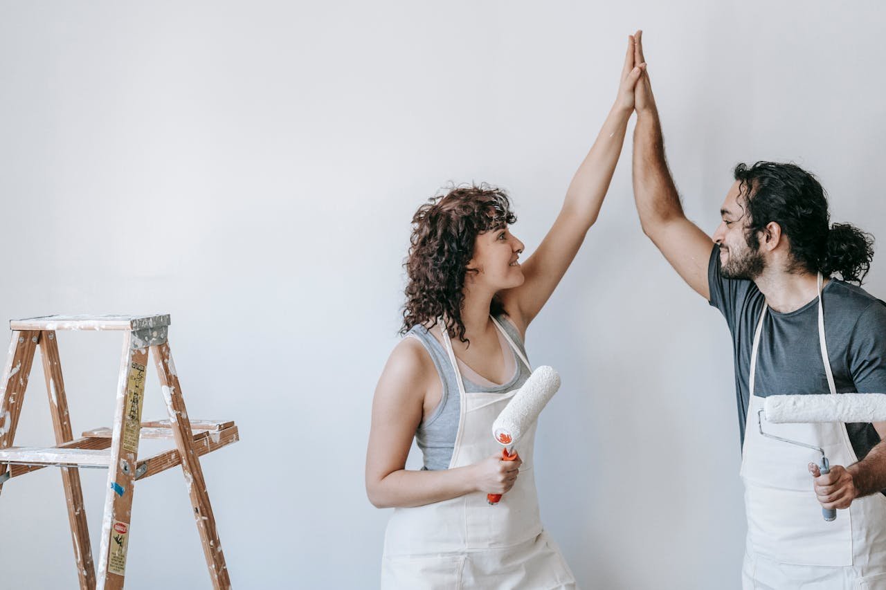 Close-up of a couple holding keys, symbolizing homeownership and investment.