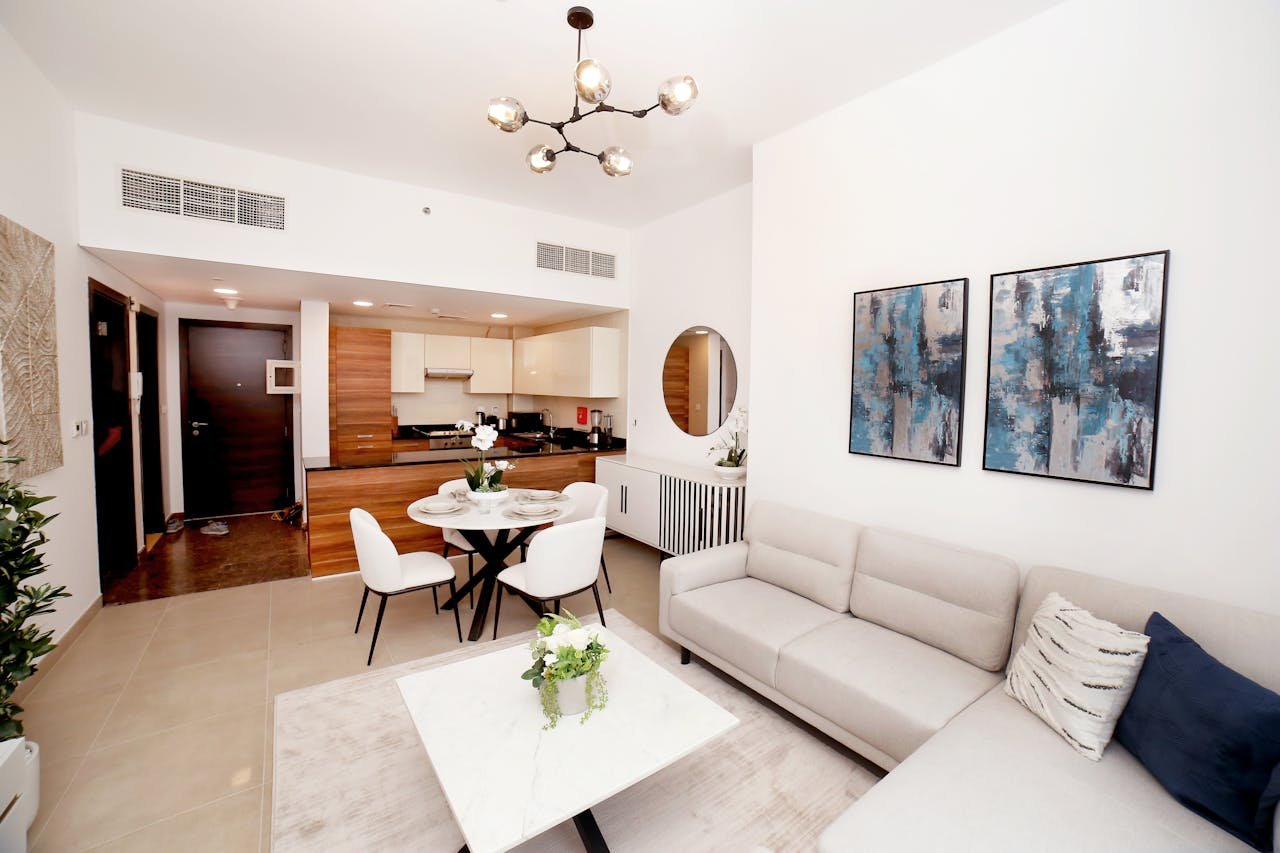 Contemporary living room with an open kitchen, modern decor, and cozy ambiance.