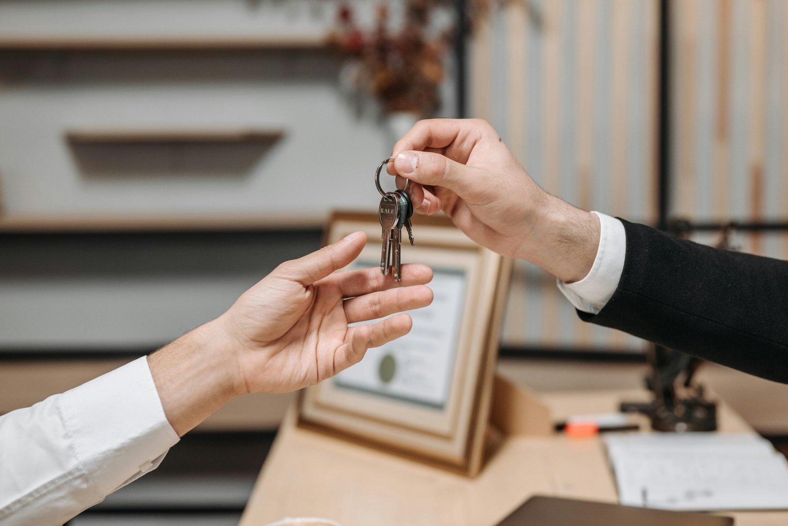 Close-up of a couple holding keys, symbolizing homeownership and investment.